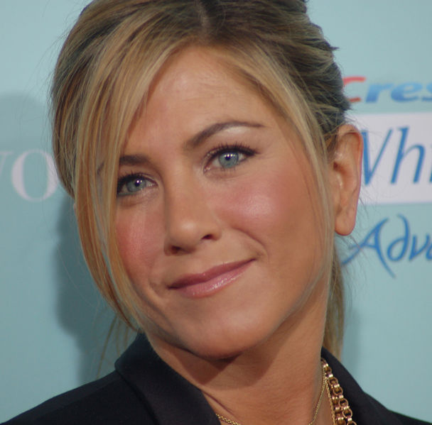 A close up of jennifer aniston 's face with blue eyes.