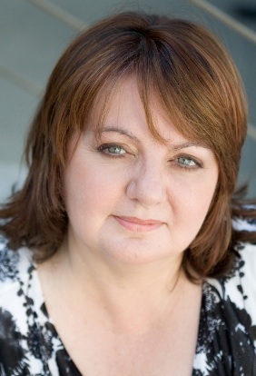 A woman with brown hair and green eyes.