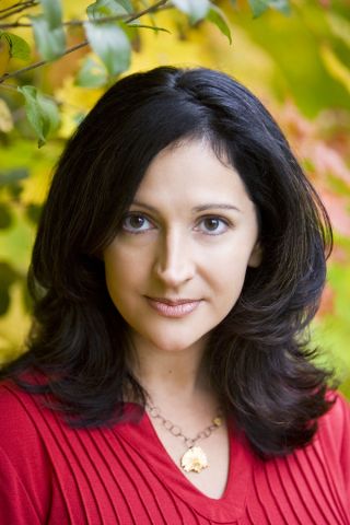 A woman with long black hair wearing red.