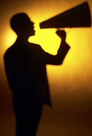 A man is holding something up to his face
