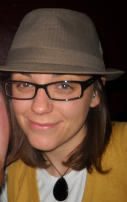 A woman wearing glasses and a hat.