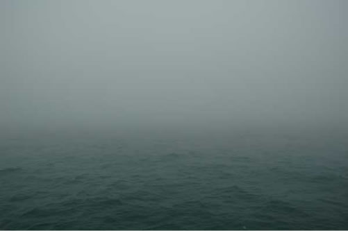 A large body of water with a lot of fog