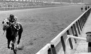 Horse racing on a dirt track.