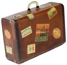 A brown suitcase with stickers on it.